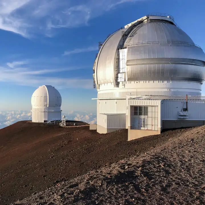 Dômes d'observatoires blancs au sommet d'une montagne, ciel bleu