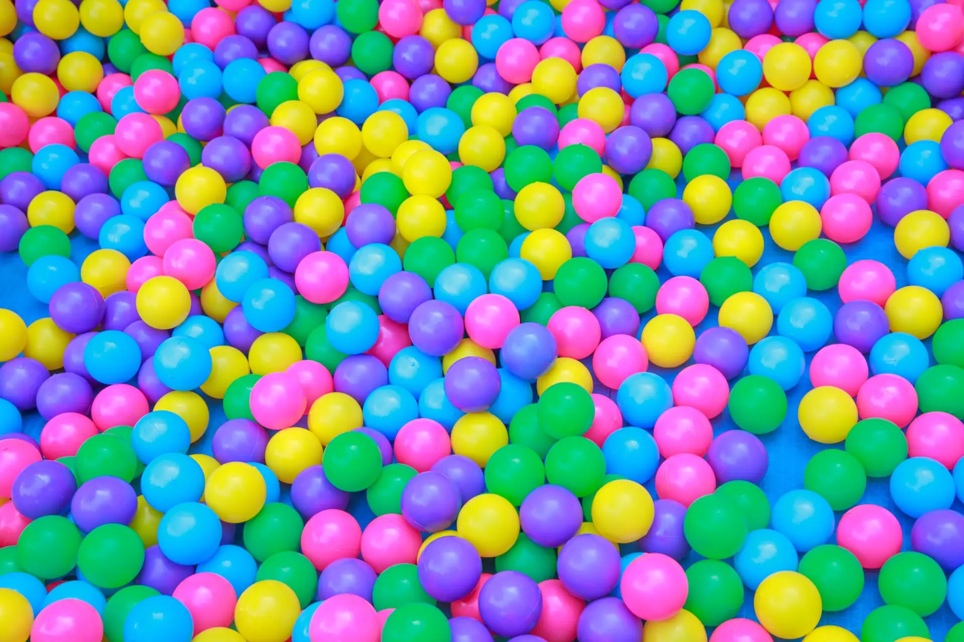 Heap of brightly coloured plastic balls seen from above